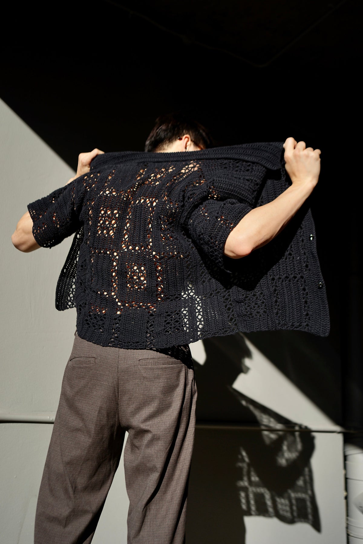 Black crochet lace shirt for men with an openwork geometric design. Breathable, stylish, and perfect for layering. Available as a digital PDF crochet pattern for DIY makers.